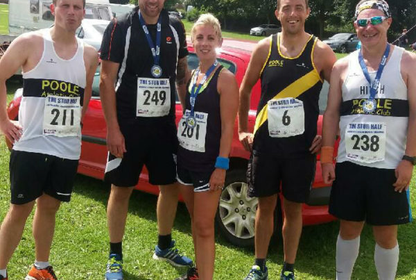 Poole Ac runners outside with medals from the Stur Half Marathon
